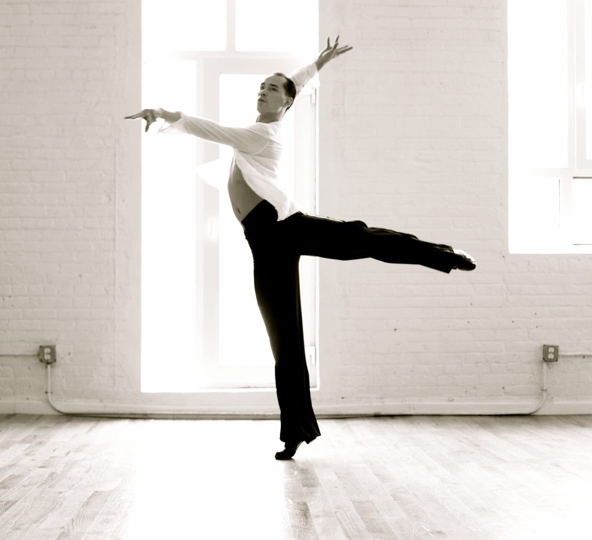 Michael Choi in an extended line in a white-brick studio